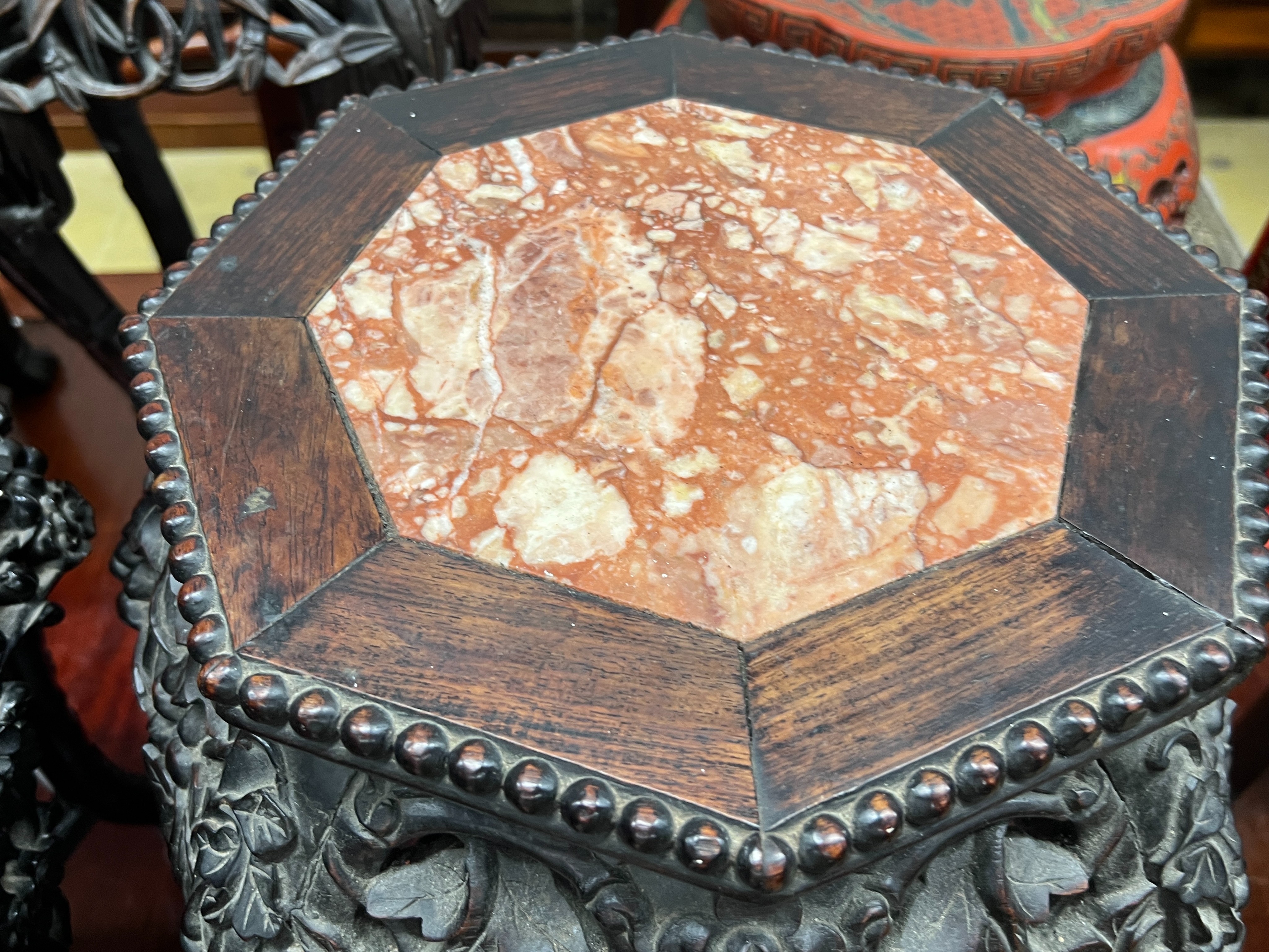 A near pair of Chinese marble top octagonal carved hongmu vase stands, width 40cm, height 62cm